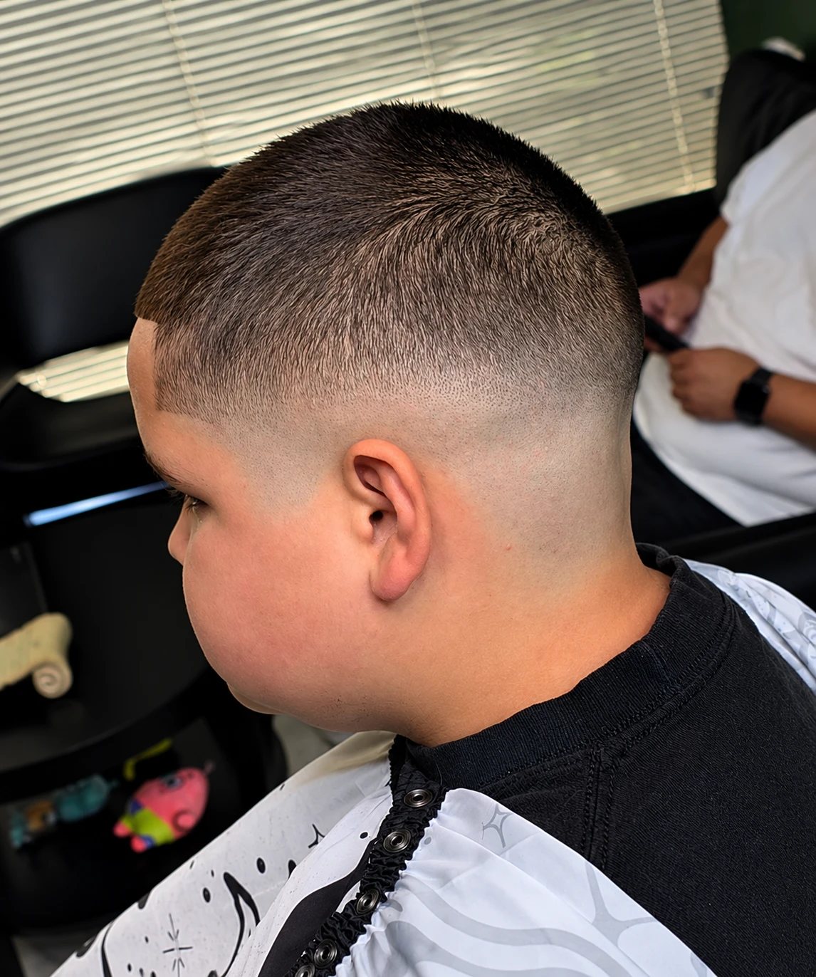 Skin fade with a short textured top and a crisp lineup